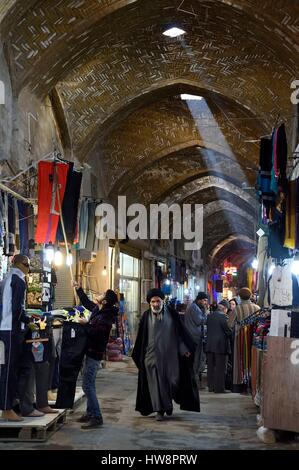 Iran, Provincia di Isfahan, Isfahan, mullah nel bazar-e Bozorg (Gran Bazaar), un massiccio bazaar coperto che risale quasi 1300 anni, negozio di abbigliamento Foto Stock