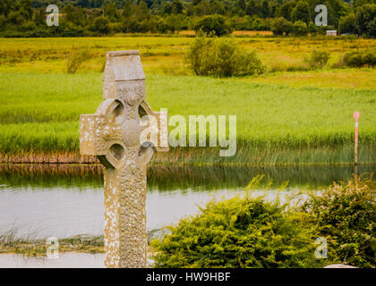 Antiche lapidi e croci celtiche a Clonmacnoise insediamento monastico nella Contea di Offaly. Foto Stock