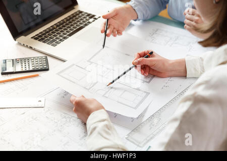 Giovani donne architetto e designer che lavora sul progetto blueprint di nuovi appartamenti. Foto nozione di lavoro sui disegni tecnici Foto Stock