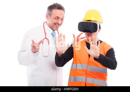 Medico guardando il costruttore cercando occhiali per realtà virtuale isolato su sfondo bianco Foto Stock