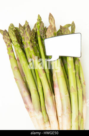 Mazzetto di crudo fresco uncoocked asparagi e divertente comico etichetta di stile per il prezzo di mercato del telaio verticale Foto Stock