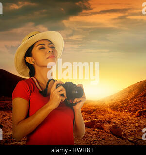 Un turista acquisizione immagine con la fotocamera sul paesaggio di montagna Foto Stock