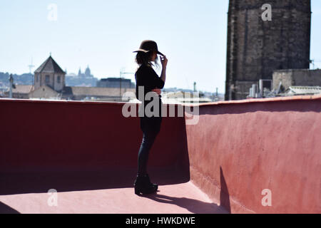Ritratto di donna bella nella HAT di profilo sulla terrazza a Barcellona, Spagna Foto Stock