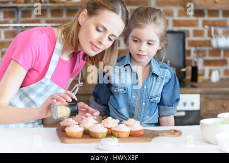 Ritratto della figlia e madre come decorare le tortine con coriandoli Foto Stock