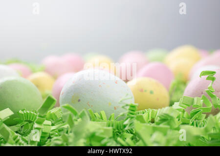 Malted Candy Pasqua uova deposte su un letto di verde carta crespa Foto Stock