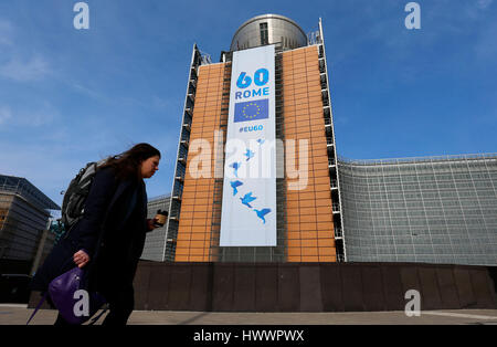 Bruxelles, Belgio. 24 Mar, 2017. Una passeggiate a piedi passato la Commissione europea edificio su cui un banner viene visualizzato per celebrare il sessantesimo anniversario del Trattato di Roma, a Bruxelles, in Belgio, 24 marzo 2017. L'UE-27 leader si incontreranno a Roma sabato per celebrare il sessantesimo anniversario della firma del trattato e discutere circa il futuro del bloc senza la Gran Bretagna. Credito: Voi Pingfan/Xinhua/Alamy Live News Foto Stock