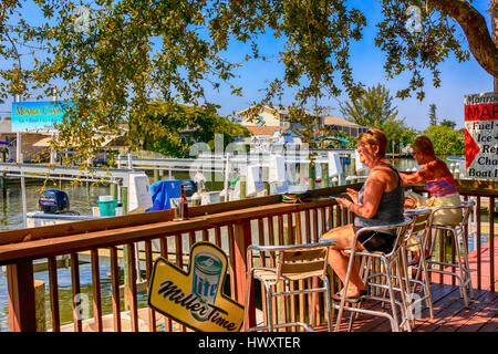 La gente seduta fuori a Woody di persone, Diners, Waterfront Restaurant presso il St James città sull isola di Pino FL Foto Stock