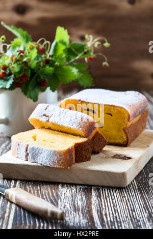 In casa torta di mais e fragoline di bosco in una tazza bianca sul tavolo di legno Foto Stock