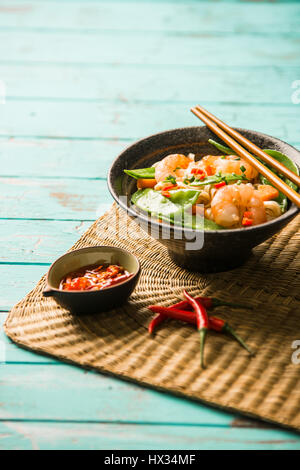 Pasta speziata con gamberoni e piselli di neve Foto Stock