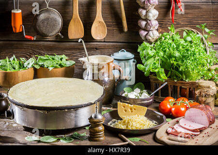 Frittelle con prosciutto e formaggio sul vecchio tavolo in legno Foto Stock