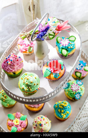 Focaccine dolci con decorazione dolce sul vecchio tavolo bianco Foto Stock