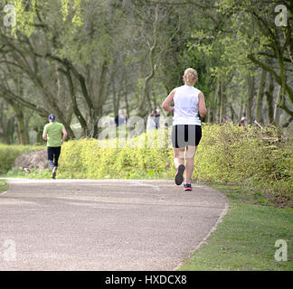 People jogging in park on sunny spring day afternoon,Stoke on Trent,Staffordshire,United Kingdom,26th March,2017. Foto Stock