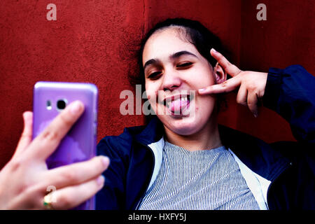Teenage ragazza spagnola prendendo selfies, Barcelona, Spagna. Foto Stock