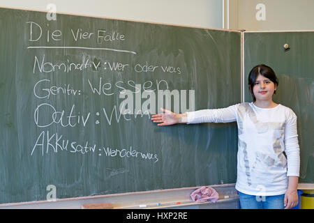 Ragazza facendo grammatica tedesca presso la scuola primaria Foto Stock