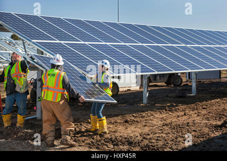 Detroit, Michigan - Lavoratori costruire un 2 megawatt di energia solare per installazione DTE Energy su ex terreni abbandonati. Detroit la popolazione è diminuita da due-thi Foto Stock