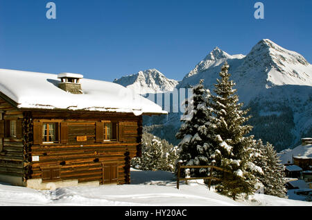 Questo stock foto mostra le piccole casette di legno casa di montagna in un bellissimo paesaggio invernale in Arosa una stazione sciistica in Svizzera. Arosa è circondato b Foto Stock