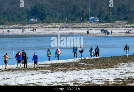 Boltenhagen, Germania. 27 Mar, 2017. La gente a piedi lungo la spiaggia di Boltenhagen, Germania, 27 marzo 2017. Circa due settimane e mezza prima le vacanze di Pasqua, la locale industria del turismo sta dando dei calci a fuori la sua nuova stagione a Rostock il 28 marzo. A seguito di una stagione di record nel 2016 che ha visto un totale di 30,3 milioni di pernottamenti, l'industria spera di aumentare il numero di ospiti stranieri di quest'anno. Foto: Jens Büttner/dpa-Zentralbild/dpa/Alamy Live News Foto Stock