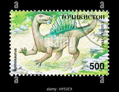 Francobollo dal Tagikistan raffigurante un dinosauro spinosaurus Foto Stock