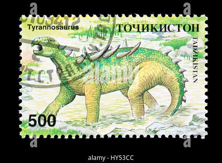 Francobollo dal Tagikistan raffigurante un dinosauro tyrannosaurs Foto Stock