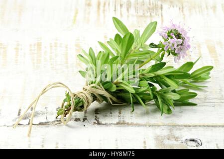 Mazzetto di timo fresco su sfondo di legno Foto Stock