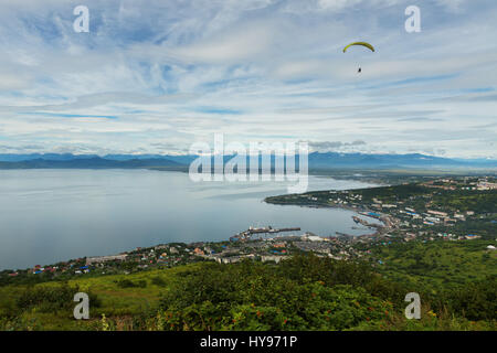 Parapendio volando sopra la baia Avacha dalle colline Mishennaya Foto Stock