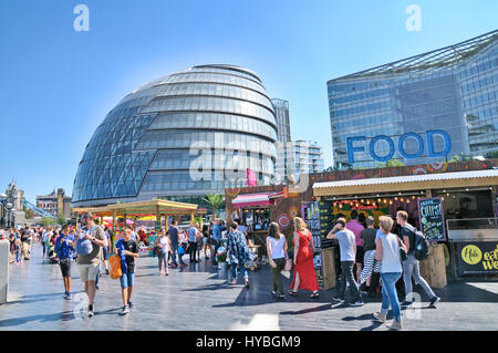 Più Londra Riverside e Municipio. Le persone che si godono il tempo in estate e bancarelle prodotti alimentari nella capitale. Foto Stock