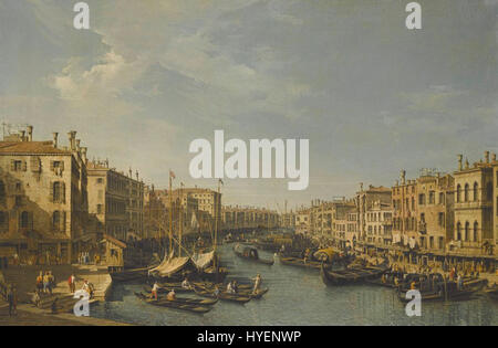 Il dipinto di Bernardo Bellotto "Venezia, il Canal grande, guardando a sud-ovest, dal Ponte di Rialto al Palazzo Foscari" cattura una vista panoramica del Canal grande di Venezia, mostrando la sua architettura e i suoi corsi d'acqua caratteristici. L'opera d'arte mette in risalto la vivace vita cittadina e lo skyline veneziano, dimostrando l'abilità di Bellotto nel rendere i paesaggi urbani con notevole precisione e dettaglio. Foto Stock
