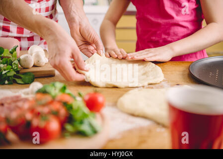 Madre e figlia preparare la pizza in cucina Foto Stock