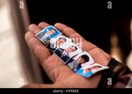 MOSUL, IRAQ: In un villaggio liberato, un civile mostra le foto dei suoi familiari che sono stati uccisi in coalizione incursioni aeree. Immagini che mostrano curdo forze militari di difesa contro lo Stato islamico nei pressi di Mosul, Iraq sono state acquisite. La serie di scatti anche mostrare ciò che la vita è diventata per i civili di appena liberato villaggi vicino alla città che è ancora sotto controllo è. Altre foto mostrano i volontari il trattamento di ferite che i rifugiati che sono riusciti a fuggire di Mosul. Queste foto sono state scattate dal fotografo di conflitto Jan Husar a poche miglia da Mosul. Jan Husar / mediadrumworld.com Foto Stock