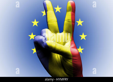 V segno dipinto a mano con bandiera rumena oltre la bandiera dell'Unione europea white Foto Stock