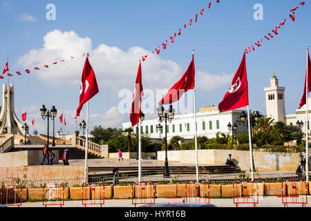 Affiancato dal sangue-bandiere rosse della Tunisia, Kasbah Square fronti la città moderna Hall e altri edifici del governo di Tunisi, Tunisia. Foto Stock