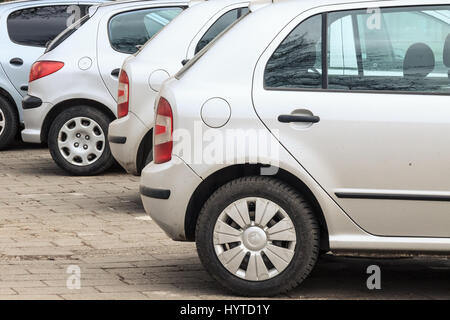 Di seconda mano auto grigio senza marca parcheggiato in un parcheggio, pronto per essere venduto foto di una fila di automobili di colore grigio di varie marche pronti per essere sol Foto Stock