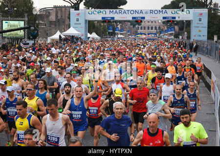 Roma, Italia - 2 Aprile 2017: la partenza degli atleti sulla Via dei Fori Imperiali, il Colosseo sullo sfondo. Foto Stock