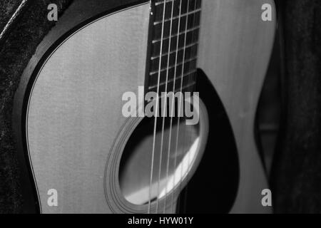 Vecchia chitarra in monocromatico e ambiente scuro. Foto Stock