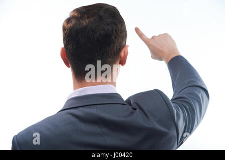 Retro dell'uomo toccando lo spazio con il dito isolati su sfondo bianco Foto Stock
