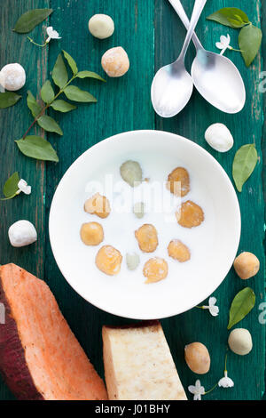 Giapponese di patate dolci gnocco di latte di cocco Thai dessert con piatto laici sullo sfondo di legno Foto Stock