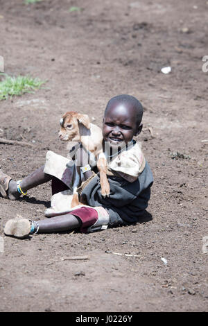 Ngorongoro Conservation Area, Tanzania - Marzo 8, 2017 : Giovane ragazzo con capra nel villaggio Masai in Ngorongoro Conservation Area, Tanzania Africa. Foto Stock