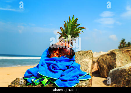 Ananas in occhiali da sole sulla spiaggia. Il concetto di un tropicale vacanza estiva. Foto Stock