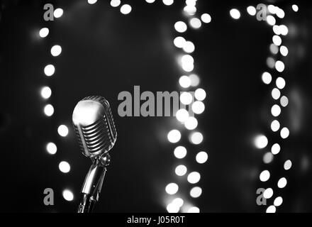 Microfono Vintage sul palco ribalta luci in bianco e nero Foto Stock