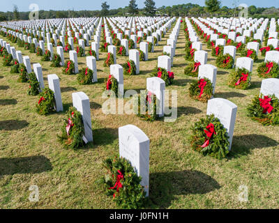 Righe della tomba di pietra con ghirlande & rosso archi a sarasota cimitero nazionale in Sarasota Florida Foto Stock