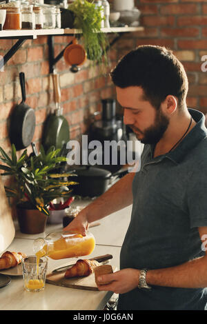 La cottura. Uomo bello in cucina Foto Stock