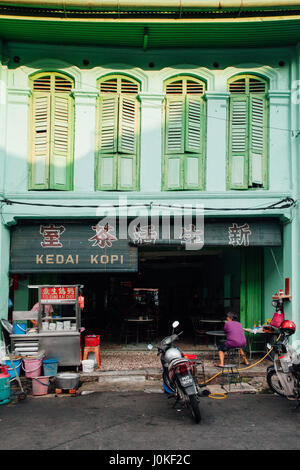 George Town, Malesia - 24 Marzo 2016: Donna si siede a tavola nel tradizionale kopitiam cafe a Chinatown, George Town, Penang, Malaysia a marzo Foto Stock