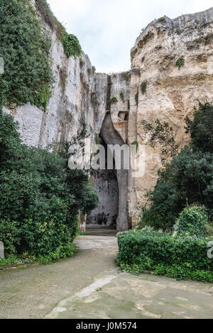 Ingresso a orecchio di Dionisio grotta in Acquario tropicale antica cava, parte del Parco Archeologico della Neapolis nella città di Siracusa, Sicilia Isola, Italia Foto Stock