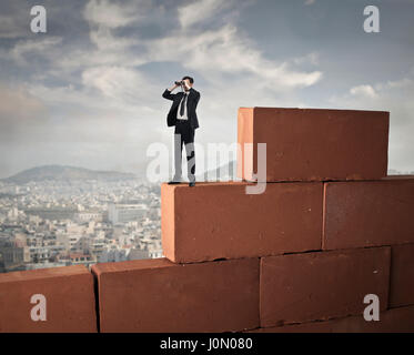 Uomo su enormi mattoni Foto Stock