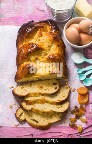 Kalacs tradizionale ungherese pane dolce con albicocche e uvetta con ingredienti sul lato Foto Stock