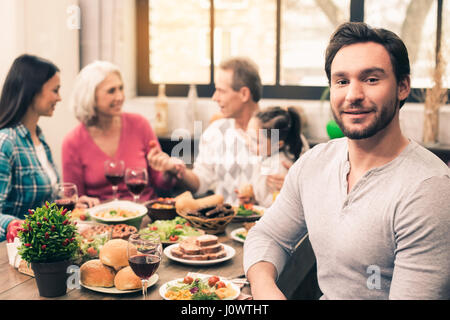 Bella famiglia avente una gustosa cena Foto Stock