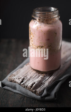 Yogurt sano sul tavolo di legno in verticale Foto Stock