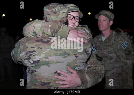 Senior Airman Erik Hjelden, 824th Base Defense Squadron fireteam stati, abbraccia i compagni di 824th BDS stati, Tech. Sgt. Chris Burris, prima della distribuzione, 11 aprile 2017, a Moody Air Force Base, Ga. Più di 100 aviatori dal 824th BDS, noto come 'Ghostwalkers,'deployed a sud-ovest Asia per fornire completamente integrato, altamente capace e forze reattive salvaguardando Expeditionary Air Force risorse. (U.S. Air Force foto di Airman 1. Classe Greg Nash) Foto Stock