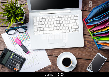 Colpo di overhead del desktop di Office con computer moderni, grafici e diagrammi, documenti e smart phone Foto Stock