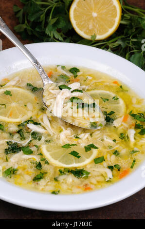 Avgolemono, greca zuppa di pollo con uova di salsa di limone, orzo e fresche foglie di prezzemolo Foto Stock